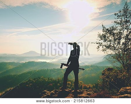 Nature Photographer Stay At Tripod On Summit And Thinking. Hilly Foggy Landscape