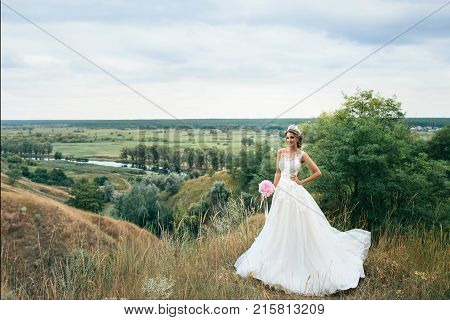 Beautiful Young Bride Girl Smiling, Standing In Wedding Dress.