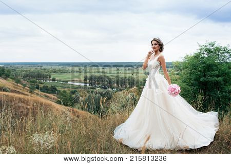 Beautiful Young Bride Girl Smiling, Standing In Wedding Dress.