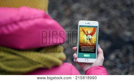 Samara, Russia - November 28, 2017: woman playing pokemon go on his iphone. pokemon go multiplayer game with elements of augmented reality.