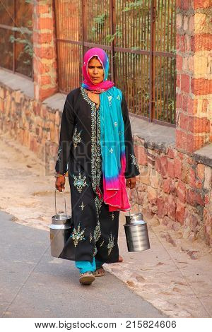 Fatehpur Sikri, India-november 9: Unidentified Woman Carries Milk Jugs In The Street On November 9,