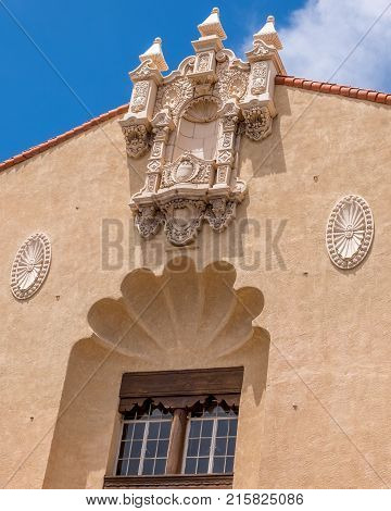 Vertical photo of traditional new mexico architecture in Santa Fe New Mexico downtown plaza on a bright sunny day with beautiful blue sky.