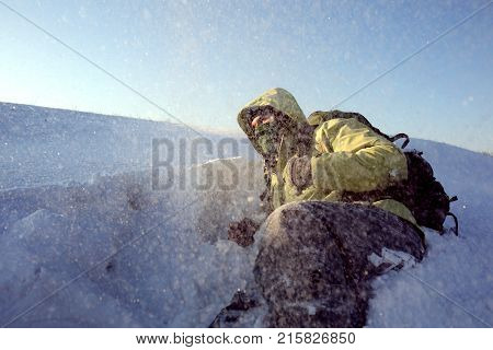 Climber in a snow storm. Man in mountains
