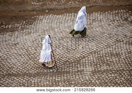 Overhead view of women in traditional dress walking on Ethiopian street.