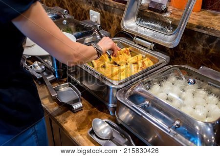 Close up metal containers with boiled eggs and toasts for buffet breakfast in hotel