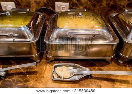 Close up metal containers with prepared dishes for buffet breakfast in hotel