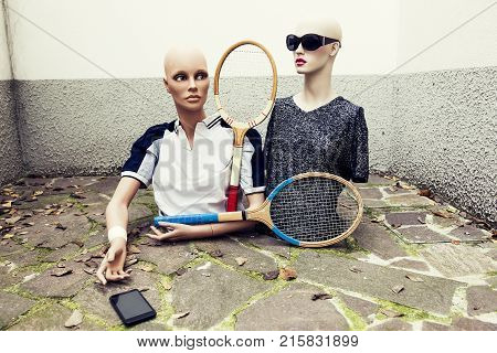 pair of dummies take a selfie dressed in seventies tennis clothes and tennis racket