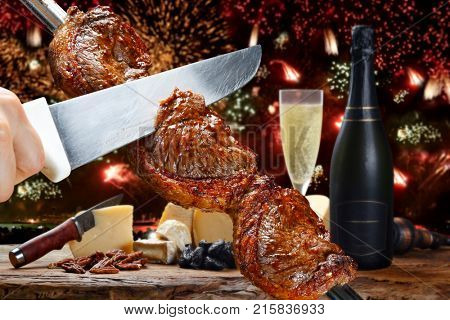 Delicious barbecue of picanha celebrating the end of the year with fireworks and champnhe