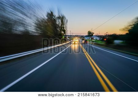 Car driving at night with motion blur