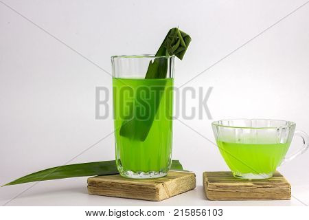 Glass Of Cold Pandan Juice - Healthy Food Against Wood,.with Pandan Green.on A White Background