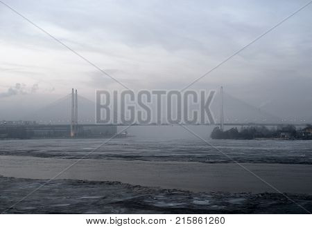 Cable stayed bridge on the outskirts of St. Petersburg at winter evening Russia.