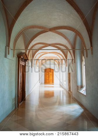 Pannonhalma, Hungary - July 28, 2016: Whote Gothic Corridor And A Bright Wooden Door At Pannonhalma