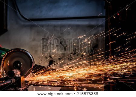 Worker are using electric cutting steel machine background