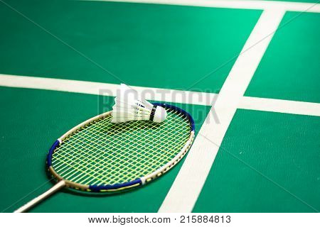 White badminton shuttlecock on a green floor at  badminton courts .Close up shuttlecocks on racket badminton at badminton courts
