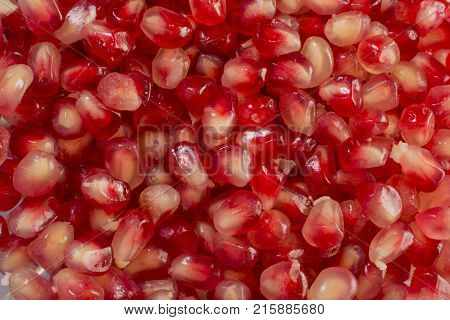 Red Background of Grain Red Grenades. Big Ripe Red Granets or Garnets. Fruits of Red Ripe Pomegranate on the White Background. Vegetarian Concept Organic Vitamins. Organic and Benefit Garnet Fruit.
