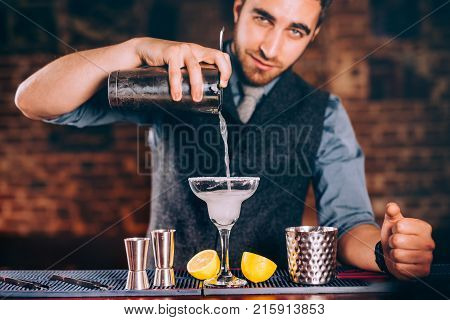 Portrait Of Handsome Bartender Using Bar Tools For Alcoholic Cocktails. Margarita With Tequila, Slic