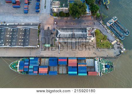 Containers yard in port congestion with ship vessels are loading and discharging operations of the transhipments in international port.