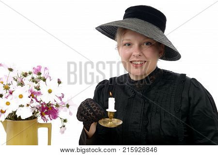 a young woman in vintage costume 1900s with candle
