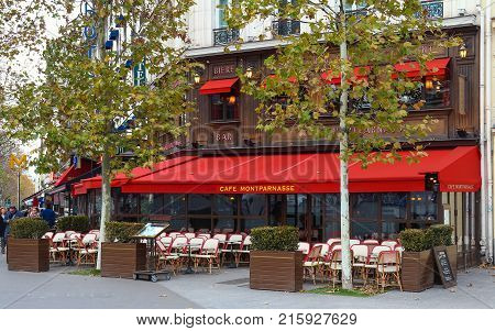 PARIS, France - November 26, 2017: View of typical Parisian cafe Montparnasse on November 26, 2017 . It is located on famous Montparnasse boulevard in Paris, France.