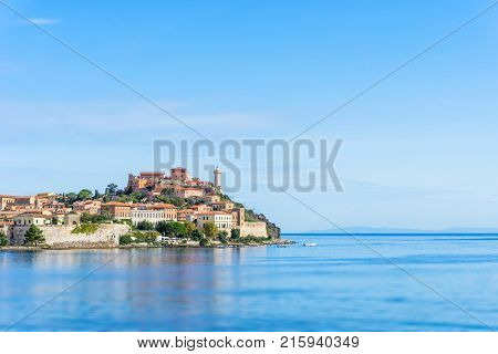 The Lighthouse And Other Buildings In The Town Of Porto Ferraio