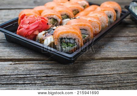 Sushi In A Black Container On A Wooden Table Colorful And Beautiful
