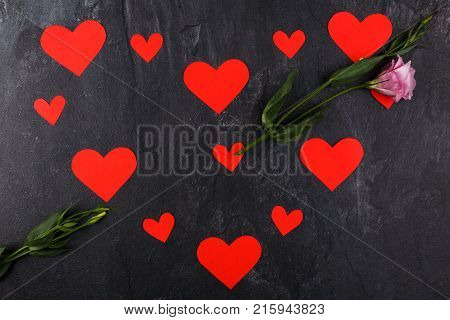 The hearts are lined up in one big heart lying horizontally. With Japanese roses in the form of an arrow passing through the heart on a stone background