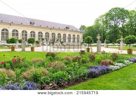 WARSAW POLAND - MAY 24 2017: Stara Oraneria an old orangery in Lazienki Park in Warsaw. Lazienki Park is 76 hectares big and therefore the biggest park in the Polish capital.