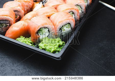 Sushi In A Black Container On A Wooden Table Colorful And Beautiful