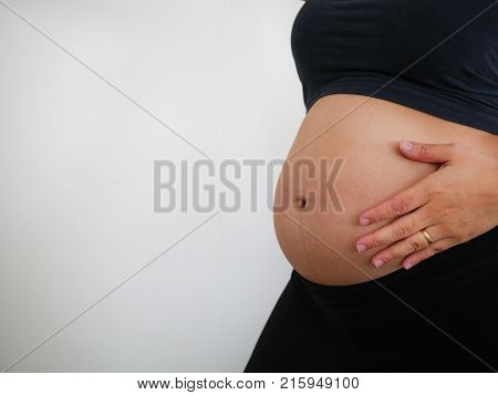 Pregnant woman shows her big naked belly