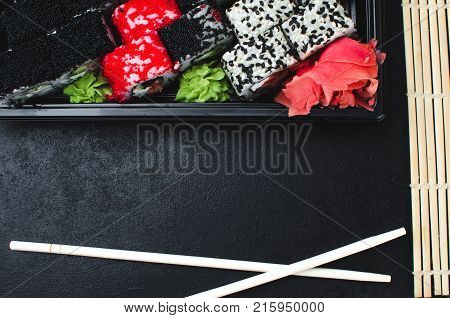 Sushi In A Black Container On A Wooden Table Colorful And Beautiful