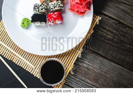 On The Plate Is White, Lined With Different Rolls, Sushi