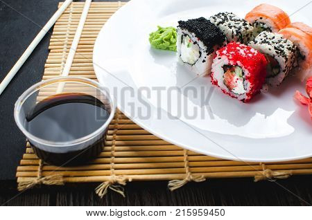 On The Plate Is White, Lined With Different Rolls, Sushi
