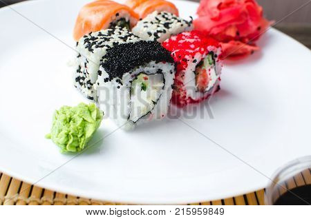 On The Plate Is White, Lined With Different Rolls, Sushi