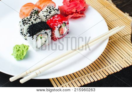 On The Plate Is White, Lined With Different Rolls, Sushi