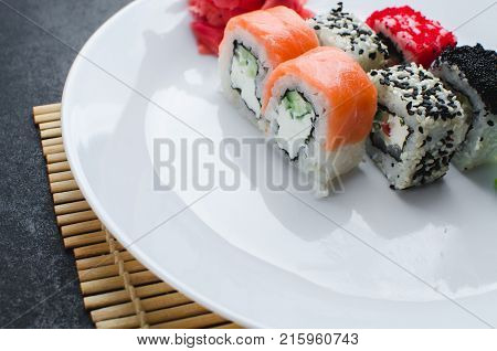 On The Plate Is White, Lined With Different Rolls, Sushi