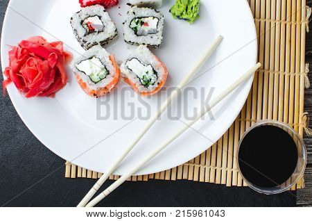 On The Plate Is White, Lined With Different Rolls, Sushi