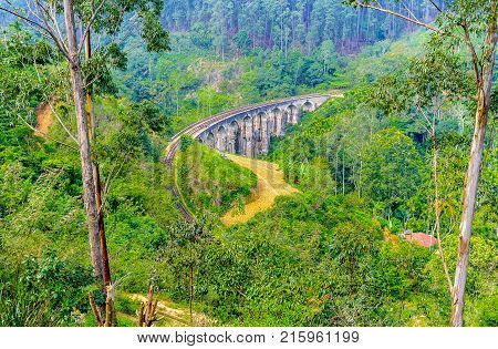 The massive construction of the iconic Nine Arch Bridge located among the green hillsides of Demodara Sri Lanka.