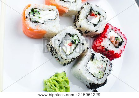 On The Plate Is White, Lined With Different Rolls, Sushi