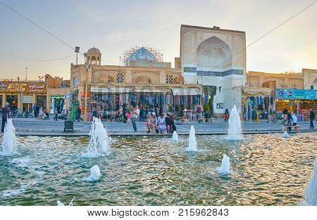 YAZD IRAN - OCTOBER 17 2017: Amir Chakhmaq square is the central tourist square with numerous market stalls cafes and benches around fountain on October 17 in Yazd