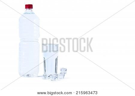 A bottle of water a glass and ice cubes isolated on white background. Pure drinking water with ice.