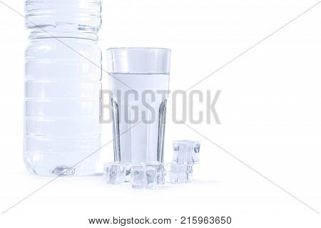 A bottle of water a glass and ice cubes isolated on white background. Pure drinking water with ice.