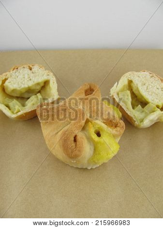 Yeast doug tartlet with vanilla pudding and rhubarb filling