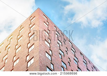 Modern architecture in new city in Netherlands. Clear building with windows and blue sky. Architexture for background. Skyscraper texture.
