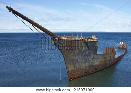 Rusting wreck of the ship Lord Lonsdale on the coast of the Strait of Magellan at Punta Arenas, Chile.