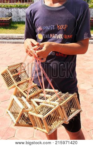 Vientiane, Laos - November 29: An Unidentified Man Sells Birds Near Pha That Luang On November 29, 2