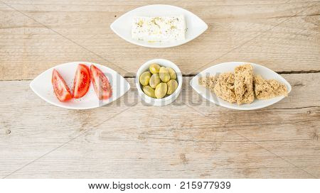 Greek Appetizers feta, olives,tomatoes and rusks. Mediterranean traditional healthy food. Top view, natural food.