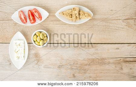 Top view of natural olives, tomatoes, feta and rusks. Mediterranean traditional healthy food. Greek food.