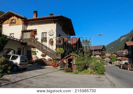 Italy Rocca Pietore - August 26 2016: the view of the typical white house with flowers in Rocca Pietore on August 26 2016 Veneto Italy.