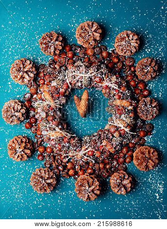 Christmas Closck Made Of Wreath Of Acorns And Cones And Dog Roseon The Cyan Background.ceative Clock