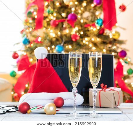 Yearend party time at the workplace with Christmas decorations and drinks on desktop